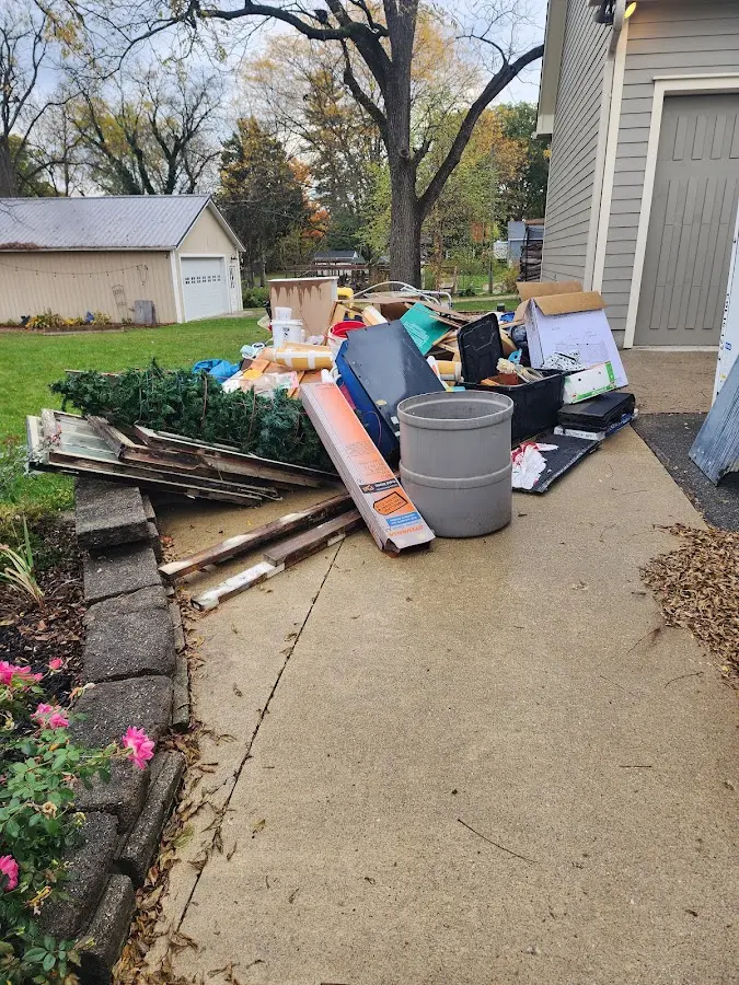 Dumpster being loaded with debris for Estate Cleanout Dumpster Rental in Indian Rocks Beach